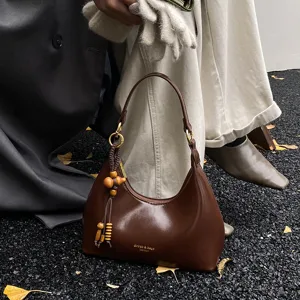 Retro brown underarm bag for women, elegant hobo shoulder handbag with vintage wood charm.