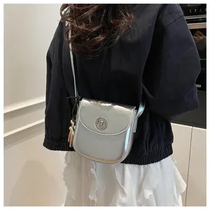 Silver phone bag detail, stylish crossbody shoulder bag with metal lock and cute charm.