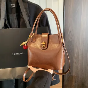 Vintage brown PU leather bucket bag for women, trendy chic shoulder and crossbody bag.