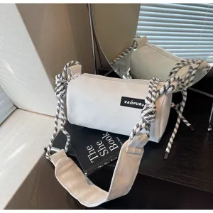 White cylindrical shoulder bag with thick patterned strap, trendy casual pillow crossbody bag for women.