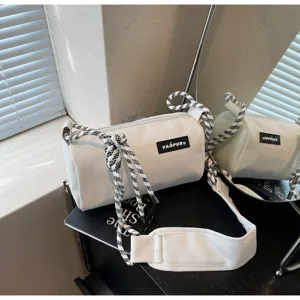 White waterproof cylindrical shoulder bag with stylish black and white braided rope straps.