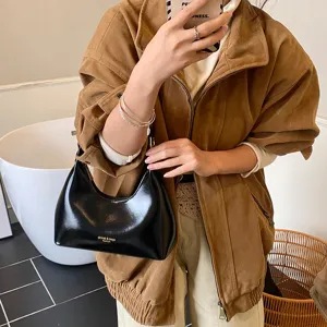 Stylish black patent leather underarm shoulder bag for women, retro fashion chic.