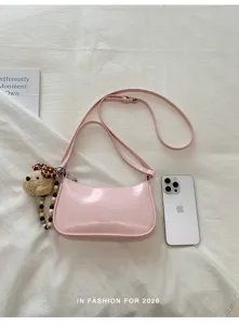 Chic pink patent leather underarm shoulder bag with cute puppy plush charm pendant.
