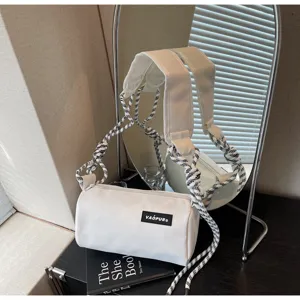 White cylindrical shoulder bag with trendy braided black and white straps for women.