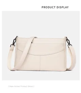 Closeup view of the genuine leather shoulder crossbody bag in off-white with fine texture details.
