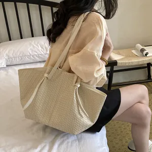 Detail shot of beige woven leather tote bag, showcasing large capacity and simple style.