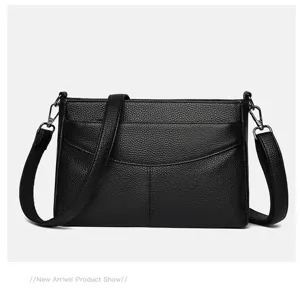 Black genuine leather shoulder bag detail, pebbled texture cowhide with metal hardware.