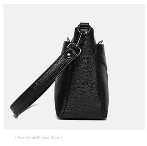 Black genuine leather handbag detail view, top layer cowhide elegant women shoulder bag.
