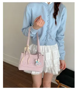 Close-up detail of the Korean style pink polka dot handbag with lace and cute bunny pendant.