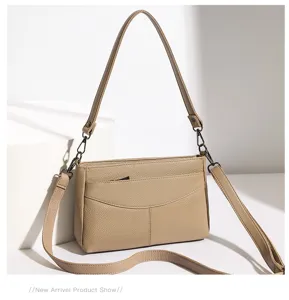 Detail view of stylish genuine leather women shoulder bag with adjustable strap and chic pocket.