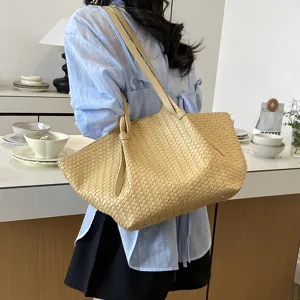 Detailed view of the woven shoulder tote bag showing its large capacity and stylish texture.