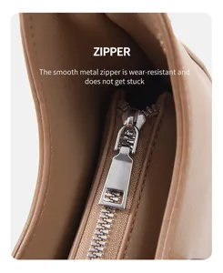 Minimalist crescent shoulder bag metal zipper detail close-up, smooth and durable design.