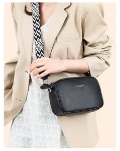 Detailed shot of women genuine leather crossbody bag with wide strap and multiple pockets