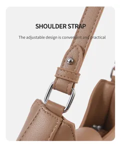 Detailed view of the brown leather shoulder bag strap with adjustable metal hardware.