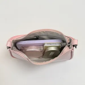 Pink PU leather underarm shoulder bag open view showing inner capacity with daily essentials