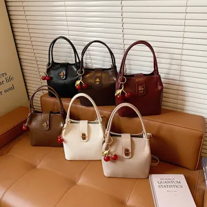 Classic vintage bucket bag for women, stylish PU leather shoulder handbag with cute cherry charm.