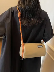 Trendy Japanese style waterproof nylon cylinder crossbody bag with striking orange rope strap for women