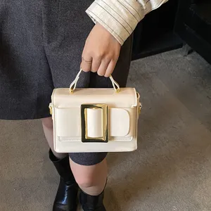 Retro patent leather handbag with statement buckle, elegant shoulder small square bag for daily commuting.