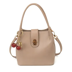 Casual bucket bag for women, retro PU leather shoulder crossbody bag with cute cherry charm.