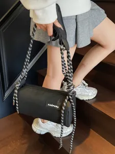 Fashion black waterproof cylindrical shoulder bag with stylish thick rope straps.
