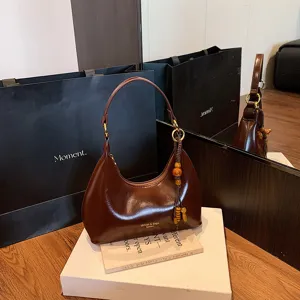 Retro brown patent leather underarm shoulder bag for women, elegant evening handbag style.