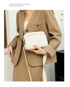Detail view of women minimalist solid litchi pattern crossbody bag worn by model, versatile.