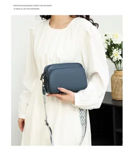 Women's blue pebble grain crossbody bag, stylish compact shoulder bag with wide strap.