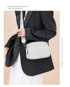 Detailed close-up view of womens crossbody bag showcasing litchi texture and wide strap.