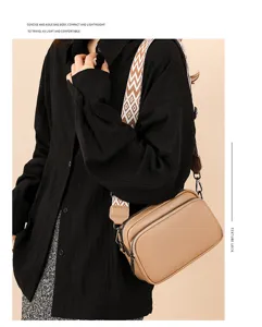 Detailed view of a stylish litchi pattern crossbody bag with wide geometric strap.