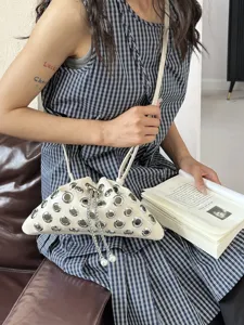 Stylish women leather crossbody bag metal grommets unique pouch design pearl drawstring