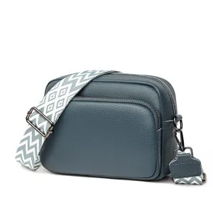 Stylish blue leather crossbody bag with patterned wide strap, perfect for daily casual wear.