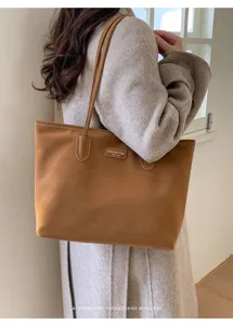 Brown suede tote bag detail, minimalist design, large capacity for daily commute style.