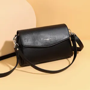 Classic black shoulder bag for women, stylish faux leather crossbody handbag with strap.