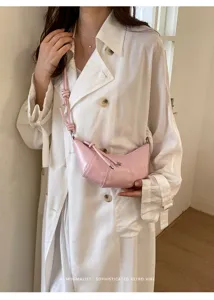 Pink croissant crossbody bag detail shot, minimalist style dumpling bag for daily use.