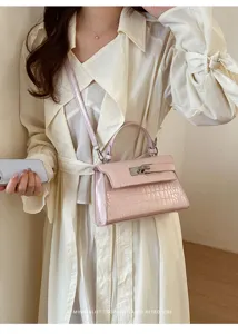 Pink crocodile pattern texture Kelly handbag detail showing stylish design and premium metal lock.