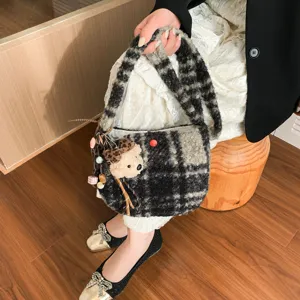 Winter wool plaid handbag detail, cozy fuzzy fabric with cute bear charm and handle.