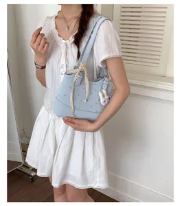 Detailed view of the Korean style light blue shoulder bag with cute lace and bunny charm.