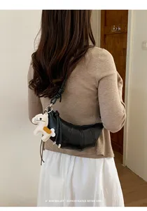 Minimalist black croissant crossbody bag for women, chic crescent dumpling shoulder bag daily.
