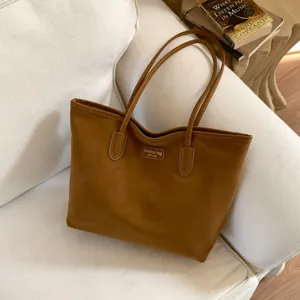 Brown large capacity tote bag for women, stylish leather shoulder bag for daily commuting.