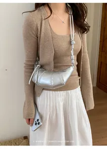Minimalist silver croissant crossbody bag for women, trendy daily commuter shoulder bag.