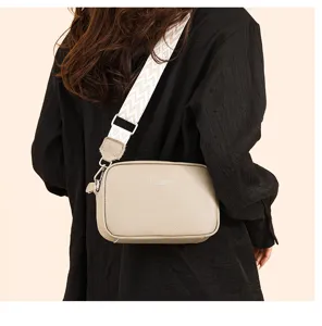 Stylish leather crossbody bag for women, featuring a wide strap and compact design for daily.