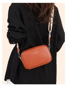Brown genuine leather crossbody bag for women with wide patterned strap, stylish camera bag.