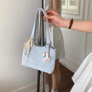 Light blue women shoulder bag with cute bunny pendant and lace ribbon for daily stylish commuting.