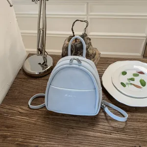 Minimalist light blue mini backpack for women, casual stylish pu leather small daypack bag.