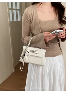 Close-up view of the elegant stone texture handbag, showcasing exquisite hardware and details.