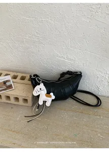 Minimalist black croissant crossbody bag with cute horse charm for daily casual commute.