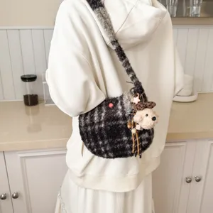 Plush plaid shoulder bag detailed view, cozy fuzzy crossbody handbag with cute bear pendant.