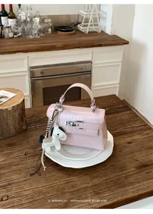 Pink crocodile pattern leather Kelly bag with cute horse charm, elegant chic handbag for women.