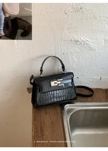 Black crocodile pattern leather handbag detail, retro style shoulder bag with metal lock.