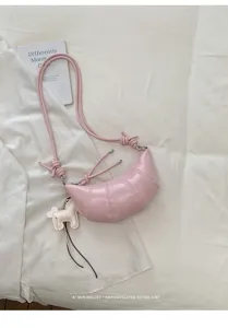 Pink PU leather croissant crossbody bag, stylish minimalist dumpling handbag for women.